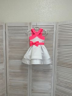 White pageant cocktail dress with pink straps and bow belt/ Pageant outfit/ Teens cocktail dress/  Custom pageant dresses This beautiful dress is made out of high quality satin. This material  has a shape and little shine. It is decorated with pink bow belt. The dress has viscose lining and zipper back. It is easy to care and comfortable to wear. The dress comes in knee length. It has tulle petticoat. The dress is perfect for all pageant events and as cocktail dress. It is absolutely stunning on Pink Party Dress With Bow Tie Back, Pink Bow Tie Back Dress For Prom, Sleeveless Party Dress With Pink Bow, Pink Satin Dress With Bow Tie Back, White Evening Dresses With Satin Bow, Fitted Pink Dress With Bow Straps, Satin Party Dresses With Sashes, Pink Fitted Dress With Bow Straps, Pink Evening Dress With Bow Straps