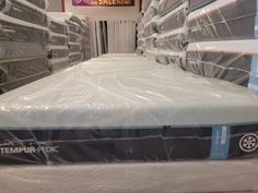 mattresses are stacked on top of each other in a store