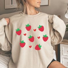 Hi, Welcome to Our Store! This Strawberry crewneck sweatshirt features a collage of adorable strawberries. This will become your new favorite botanical shirt that you reach for again and again. Makes a great gift for anyone who loves cottagecore clothes. We sell Bella & Canvas soft t-shirts that are eco friendly and Gildan sweatshirts & hoodies.  * All Solid Colors are 100% Cotton. * All Heather Colors are combined with cotton and poly mix. * The T-Shirts, Sweatshirts  are unisex. * Black text/d Strawberry Cottagecore, Clothes Cottagecore, Strawberry Outfit, Sweater Aesthetic, Strawberry Shirt, Cottagecore Clothes, Cottagecore Outfits, Botanical Shirt, Gildan Sweatshirts