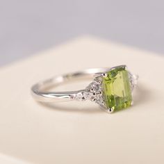 All HANDMADE ITEMS SHIP IN APPROX 8 DAYS Main Stone: Genuine natural peridot Main Stone Size: Emerald cut 6 mm x 8 mm Main Stone Weight: 1.64 carat Side Stone: CZs Height From The Ring Setting Bottom(to gemstone top): about 5.13 mm Width of Ring band Measure: gradually varied,about 1.67 to 1.91 mm Material: .925 Sterling Silver/14K White Gold/14K Yellow Gold/14k Rose Gold Engraved: Available For FreeNo more than 13 letters) Customized:Of course! Tell me what you want Includes With Order: All of Green Radiant Cut Diamond Ring With Gemstone, Green Emerald Cut Birthstone Ring With Accent Stones, Radiant Cut Green Rings With Accent Stones, Green Radiant Cut Rings With Accent Stones, Green Radiant Cut Ring With Accent Stones, Emerald Cut Peridot Ring For May Birthstone, Emerald Cut Peridot Ring In Green, Emerald Cut Peridot Green Ring, Green Emerald Cut Peridot Ring