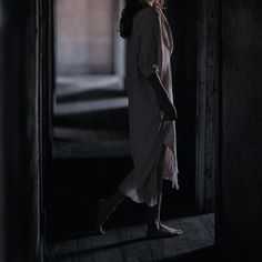 a woman is standing in an open doorway