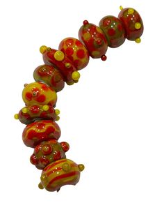 a red and yellow glass bead necklace on a white background with space in the middle