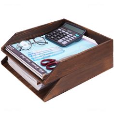 a calculator and some books in a wooden box on a white background with clippings