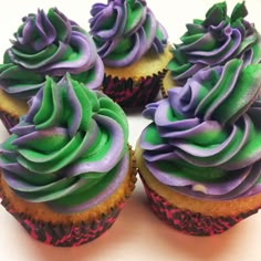 several cupcakes with purple and green frosting