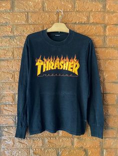 Vintage 90s OG Thrasher Magazine Flame Logo Skates T Shirt / Powell Peralta / Santa Cruz / Old Ghost Design / 90s Streetwear T Shirt Size S Condition : Good Used Size on tag : SColour : blackBrand : ThrasherMeasurement : Armpit to armpit - 18”Length - 25.5”Material : CottonMade In: USA THE SHIPPING (Your Choice Please read)1. The shipping cost is USD 20 via Malaysian Registered Postage With Tracking Number.It will take 2-4 weeks or more for delivery, depends on your custom checking.2. Add USD 10 Flame Logo, Thrasher Magazine, Powell Peralta, Skate T Shirts, Streetwear T Shirt, Skate Style, Ghost Design, 90s Streetwear, Japanese Streetwear