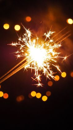 a sparkler is lit up in the dark