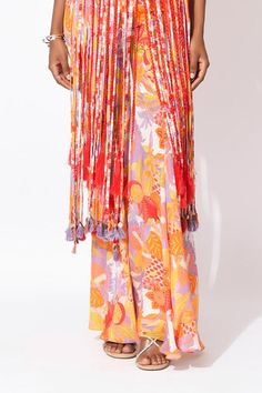 Lavender and orange crop top with floral print. Paired with floral printed pant and shoulder jacket with trims, cutwork and hand embellishments. - Aza Fashions Bohemian Palazzo Set For Summer Festive, Spring Bohemian Sets With Tassels, Spring Festive Sets With Tassels, Festive Spring Sets With Tassels, Summer Multicolor Tassel Sets, Summer Festive Sets With Tassels, Festive Summer Sets With Tassels, Orange Printed Motifs Palazzo Set, Summer Festive Palazzo Set With Tassels