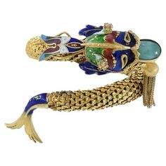 This vintage retro fish bangle showcases the timeless beauty of 18KT yellow gold, intricately adorned with exquisite enamel and jade. The perfect statement piece for any outfit, this bangle is crafted with meticulous attention to detail and embodies both luxury and elegance. 50.51 grams, Sapphire Bangle, Modern Bangle, Ruby Bangles, Gold Lariat Necklace, Amazon River, Modern Bracelets, Yellow Gold Bangle, Enamel Bangle, Diamond Bangles Bracelet