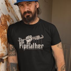 "IMPORTANT: Unisex T-Shirts runs fitted. Please order a size up for a looser fit This godfather-themed novelty clothing for Men makes a perfect present idea for him - the best plumber dad ever! This t-shirt features the funny saying \"The Pipefather\" makes an excellent present idea from kids - son, daughter, wife, or best friends on daddy's, grandpa or brother's Birthday, Christmas, Thanksgiving, Father's Day, or any gift-giving occasion! Super soft cotton and excellent quality print make one f Father's Day Fan Apparel T-shirt With Short Sleeve, Fan Apparel Short Sleeve Tops For Father's Day, Father's Day Fan Apparel Short Sleeve Tops, Father's Day Band Merch T-shirt With Short Sleeves, Father's Day Band Merch T-shirt, Plumber Humor, Green Silk Scarf, Retirement Shirts, Funny Retirement Gifts