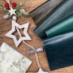 various leathers laid out on top of a wooden table with christmas decorations and other items