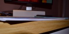 a computer monitor sitting on top of a wooden desk