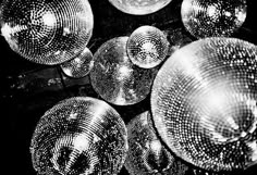 a bunch of shiny plates sitting on top of each other in front of a black background