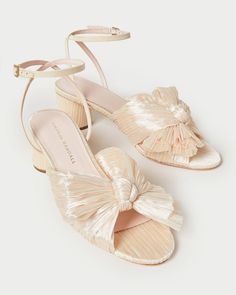 Pleated mid-heel sandal in cream fabric topped with our signature knotted bow. Features a padded footbed with gold stamped logo. Open toe with adjustable buckle ankle strap. 2 inch heel. Bow Heels, Heeled Sandal, Loeffler Randall, 5 Inch Heels, Ankle Straps, Wedge Espadrille, Heeled Sandals, Ankle Strap Sandals, High Heel Sandals