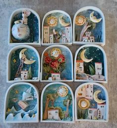 nine ceramic dishes with images of cats and houses on them, all painted in different colors