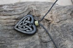 "This beautiful and unique hand-carved Celtic heart pendant will be made for you, or a loved one, in my studio on the West of Ireland. Bog Oak comes from ancient forests that once covered Ireland. Huge oaks have been buried in peat bogs and preserved from decay by the acidic and anaerobic bog conditions, sometimes for hundreds or even thousands of years. The wood is usually stained black by tannin dissolved in the acidic water. Bog-wood represents the early stages in the fossilization of wood, w Irish Love, Peat Bog, Celtic Heart, Old Irish, Ancient Forest, Love Knot Necklace, Love Knot, Jewelry Unique, Knot Necklace