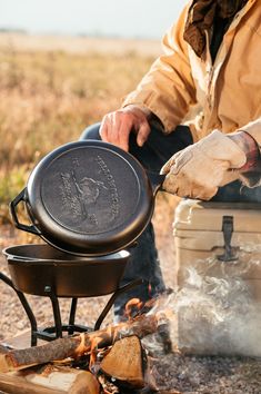 a man cooking food over an open fire