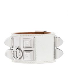 This is an authentic HERMES Epsom Collier de Chien CDC Bracelet S in Blanc White.  Collier de Chien simply means "dog collar" and this sporty bracelet replicates the elements of a dog collar in a way that is sophisticated and stylish. It has a lovely wide leather band of swift calfskin leather in chalk white. A palladium top plate with four studs and a ring and a studded palladium adjustment plate.  Wear this unique bracelet with the iconic style of Hermes. Designer Silver Leather Bracelet With Palladium Hardware, Modern White Bracelet With Strap, Modern White Bracelet, Luxury White Cuff Bracelet, Luxury Silver Leather Bracelet With Palladium Hardware, Luxury White Gold Bracelets With Silver-tone Logo, Luxury White Leather Jewelry, Designer Adjustable White Bracelets, Luxury White Cuff Bracelets