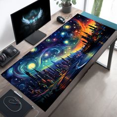 a computer desk with an artistic painting on the top and two monitors in the background