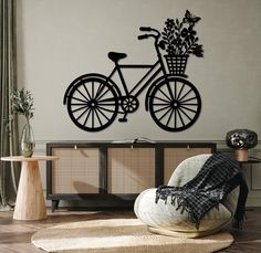 a living room with a bicycle and flowers on the wall