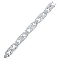 An Art Deco Cartier Paris Diamond Bracelet with French Marks Numbered and made in Platinum. The total diamond weight is appx. 20 carats. The total weight of the bracelet is 39.60 grams. The total length is 7 3/8 inches. Formal Art Deco Diamond Tennis Bracelet, Art Deco Diamond Tennis Bracelet For Anniversary, Diamond Art Deco Tennis Bracelet For Anniversary, Art Deco Tennis Bracelet With Diamond Accents For Anniversary, Art Deco Anniversary Tennis Bracelet With Diamond Accents, Art Deco Diamond Bracelets For Anniversary, Art Deco Brilliant Cut Diamond Bracelet For Anniversary, Dazzling Diamond Bracelet With 17 Jewels For Anniversary, Cartier Diamond Bracelet As A Gift