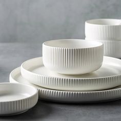 white dinnerware set on grey surface with plates