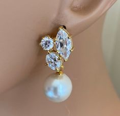 Pearl Rhinestone Earrings in Gold Cubic Zirconia rhinestone cluster earrings posts elegant chic classy Mothers Day Gift wedding earrings Come in a Gift Box! These earrings have large 12mm soft White crystal pearls and measure 1.25 inches long and are 1/2 inch wide. To see more jewelry visit my shop at http://www.AlexiBlackwellBridal.Etsy.com Elegant Clip-on Diamond Earrings For Anniversary, Gold Pearl Earrings With Diamond Accents And Cubic Zirconia, Elegant Anniversary Clip-on Diamond Earrings, Elegant Gold Clip-on Earrings With Diamond Accents, Elegant Gold Cluster Earrings For Formal Events, Elegant Clip-on Earrings With Diamond Accents For Formal Occasions, Elegant Wedding Diamond Earrings With Accents, Elegant Anniversary Clip-on Earrings With Diamond Accents, Elegant Wedding Diamond Earrings