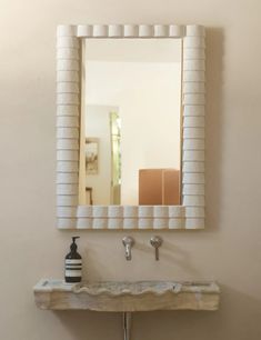 a bathroom sink with a mirror above it