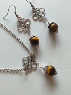 Tiger's eye Silver jewelry set earrings and necklace Victorian jewelry set Boho jewelry set tiger eye jewelry long earrings brown earrings Tiger's eye Victorian jewelry set necklace and earrings . Bohemian jewelry set necklace and earrings . Beautiful silver-tone Antique style Tiger eye set necklace and earrings . Silver-tone filigree set earrings and  pendant necklace . Victorian style earrings and necklace . Boho earrings and necklace. Romantic jewelry set earrings and necklace. Beautiful earr Elegant Brown Metal Jewelry, Brown Spiritual Dangle Jewelry, Elegant Copper Jewelry With Natural Stones, Elegant Brown Natural Stone Jewelry, Amber Wire Wrapped Drop Earrings, Spiritual Nickel-free Brown Jewelry, Handmade Amber Metal Jewelry, Nickel-free Brown Jewelry For Gifts, Elegant Handmade Brown Jewelry