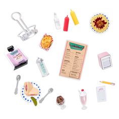 the contents of a play food set are arranged on a white surface with scissors and other items