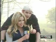 a young man and woman are on the set of news