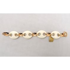 This is part of Chairish’s Costume Jewelry assortment.  Goldtone and white resin oval links bracelet with spring ring clasp. Marked "NAPIER." Measures: 8 7/8 inches long by 1 inch wide. Due to the thickness, the actual interior circumference is about 7 1/2 inches. Excellent condition-still has its original tag. The original retail was $7.50 which is worth about $46 today. A goldtone and silvertone version of this necklace was featured in a 1974 advertisement. A goldtone and black resin version o Classic White Link Bracelets, Modern White Link Jewelry, Modern White Oval Link Jewelry, Elegant White Oval Link Bracelets, Elegant White Oval Link Bracelet, Black Resin, Spring Rings, Link Bracelets, Costume Jewelry