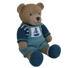 a brown teddy bear wearing a blue sweater