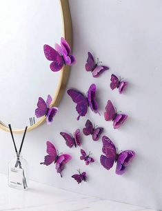 purple butterflies are flying in front of a mirror