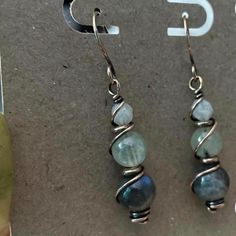 the earrings are made with wire and labradorite beads, on top of each other