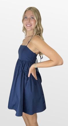 A game changer on those warm days. The bodice has a straight neckline with spaghetti straps that cross in back and create the fit. The full skirt has inset gathered pockets that add to an elevated fun style. You will look cute and beat the heat in this dress. Great for those warm gamedays! Color- Navy (Also Available in Crimson, Red, Burgundy and Orange) 100% Cotton Lining- 97% Polyester 3% Spandex Cotton A-line Dress With Adjustable Straps, Summer A-line Dress With Crisscross Straps, A-line Sundress With Smocked Back For Day Out, Daywear Spaghetti Strap Dress With Smocked Back, Cotton Sundress With Fitted Bodice, Day Out Dress With Ruched Bodice And Sweetheart Neckline, Beach Dress With Sweetheart Neckline And Straps, Day Out Dress With Sweetheart Neckline And Ruched Bodice, Summer Sundress With Ruched Bodice And Sweetheart Neckline