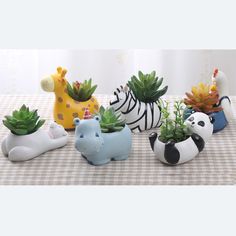 small ceramic animal planters with succulents and cacti in them