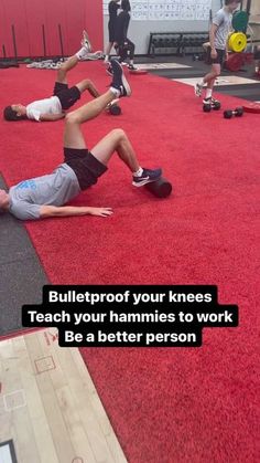 a man laying on the ground in front of other men doing exercises with their skateboards