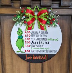 the grinch christmas door hanger is decorated with green and red bows, holly wreaths, and an i'm book list