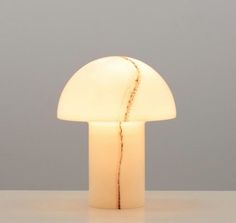 a white mushroom shaped light sitting on top of a table