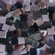 a pile of purple and black glass tiles