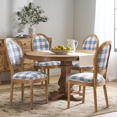 a dining room table with blue plaid chairs