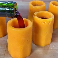 some orange candles are being poured with wine