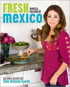 a woman standing in front of a counter with food on it