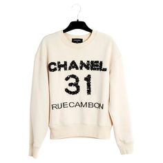 Top Chanel sweatshirt Pre Fall 2020 or Métiers d'Art collection "31 rue Cambon" in cotton fleece, Chanel motif embroidered with ribbon, leather, sequins and pearls, round neck, long sleeves, ribbed finish. Size S or 36FR: middle 52 cm, chest 47 cm, length 56 cm, sleeves 51 cm. The composition label has been cut out but this is its only trace of use, the sweatshirt has been dry cleaned and it appears to be in new condition. Luxury Winter Sweatshirt With Letter Print, Luxury Crew Neck Sweatshirt With Letter Print, Casual Crew Neck Sweater With Sequins, Luxury Cotton Sweatshirt With Embroidered Logo, Luxury Cotton Sweatshirt For Fall, Luxury Embroidered Logo Sweatshirt For Fall, Luxury Crew Neck Sweatshirt For Fall, Luxury Cotton Crew Neck Sweatshirt, Luxury Crew Neck Sweatshirt For Streetwear