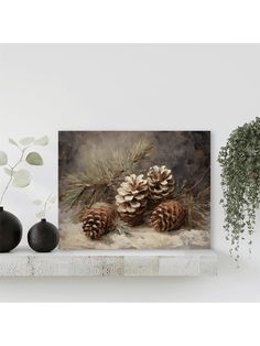 two pine cones are sitting on a mantle