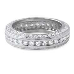 a white gold ring with rows of round brilliant cut diamonds set in the center and sides