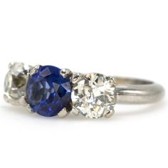 three stone diamond and blue sapphire ring in white gold with two diamonds on each side