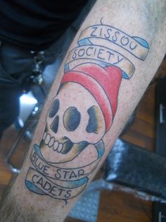 a man's arm with a skull tattoo on it