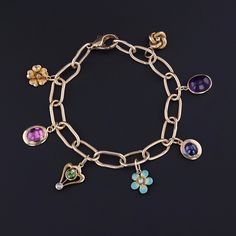 An elegant charm bracelet created from antique stickpins! This bracelet is 14k gold and features 7 charms -- a 14k gold and pearl flower, a 14k gold amethyst cabochon, a 10k pearl and enamel flower, a 14k gold sapphire doublet with a fracture on the side visible under magnification, a 14k diamond love knot, a 14k peridot and diamond charm, and a 14k foil backed amethyst charm. The bracelet measures 7 inches long and weighs 15.63 grams. It is in great condition. Note: The antique box in the photo Gold Charm Bracelet, Antique Boxes, Diamond Charm, Love Knot, Enamel Flower, Pearl Flower, Find Beauty, Gold Charm, Jewelry Findings