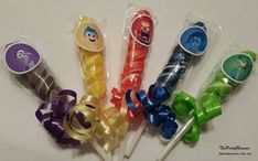 six different colored toothbrushes wrapped in cellophane and bowknots